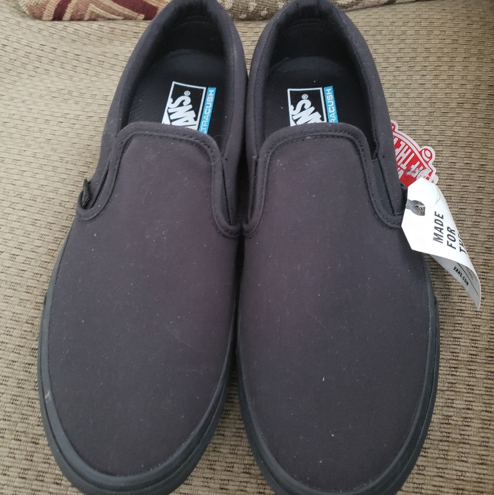 Men's 10.5 women's 12 black slip on VANS shoes